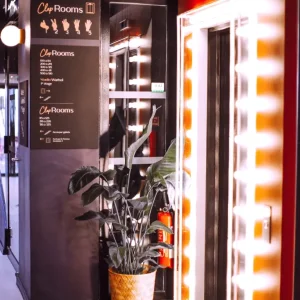 Korridor zum Veranstaltungsbereich im ClapClap Hotel Straßburg mit Hollywood-Spiegel, Beschilderung und rotem Teppich